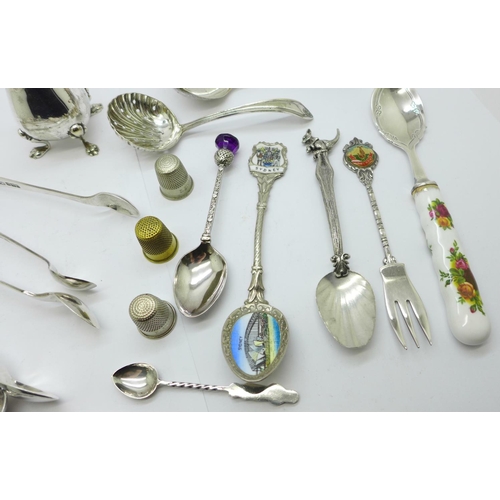 874 - A collection of silver, two pairs of sugar bows, pill box, mustard spoon, tooth pick, 137g and a col... 