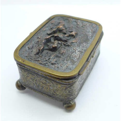 881 - A metal and silk lined jewellery casket with hunting scene on lid, mark FC on base, 6.5cm x 4.5cm