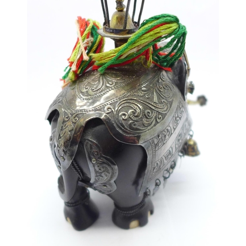 886 - A gem set and white metal embellished carved wooden Indian elephant, 13.5cm, a/f