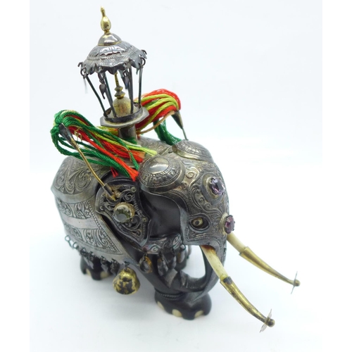 886 - A gem set and white metal embellished carved wooden Indian elephant, 13.5cm, a/f