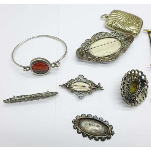 991 - A silver Lincoln Cathedral brooch, lacking pin, four other brooches, an agate set bangle, a vesta an... 