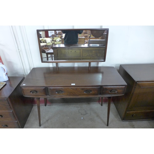 123 - An Ercol dark elm Windsor dressing table and stool