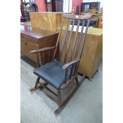 154 - A teak rocking chair