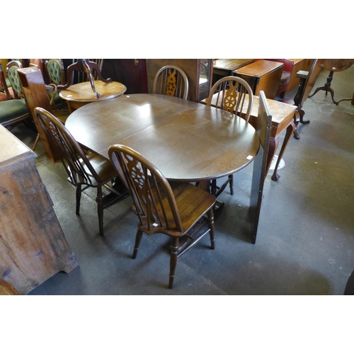 303 - An Old Charm oak extending dining table and four chairs