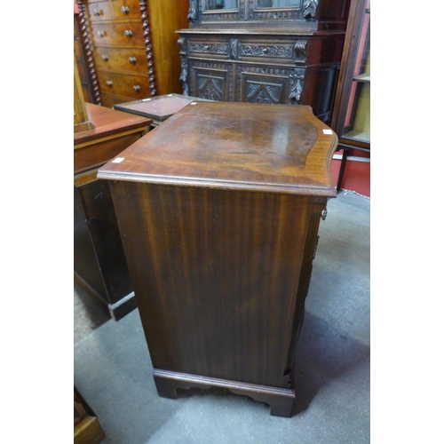 106 - A George III style mahogany serpentine bachelors chest of drawers