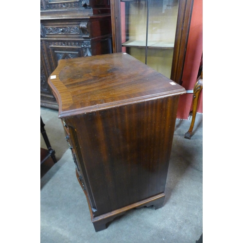 106 - A George III style mahogany serpentine bachelors chest of drawers