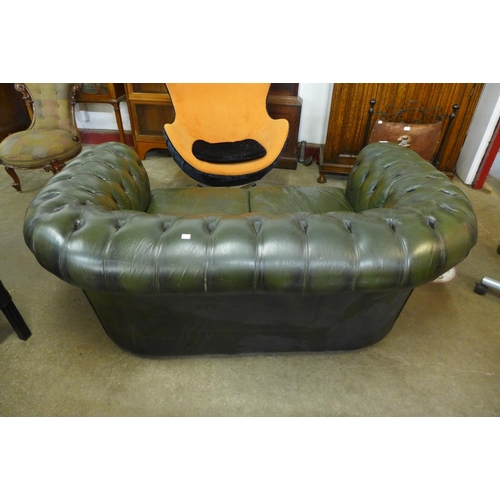 116 - A green leather Chesterfield settee