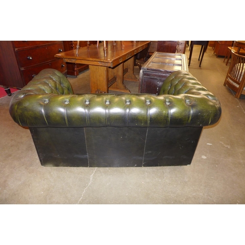 118 - A green leather Chesterfield settee