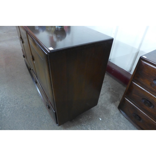 124 - An Ercol dark elm Windsor sideboard