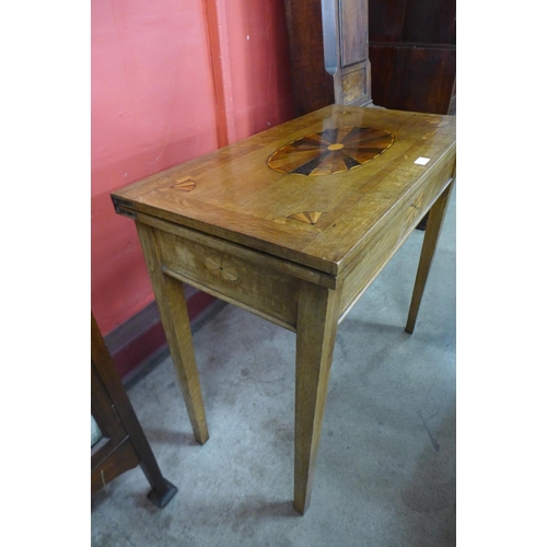 89 - A George III inlaid oak rectangular fold over card table