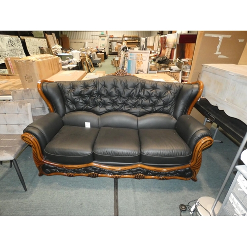 3206 - A darkwood framed/black upholstered three seater sofa (H107cm x W195 x D90cm) * this lot is subject ... 