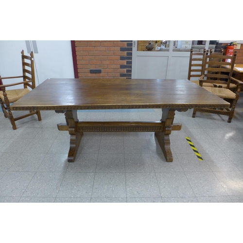 106 - A Nigel Griffiths oak refectory table and six chairs (table dimensions; 74cms h, 90cms w, 182cms l