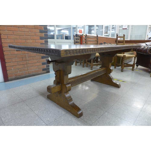 106 - A Nigel Griffiths oak refectory table and six chairs (table dimensions; 74cms h, 90cms w, 182cms l