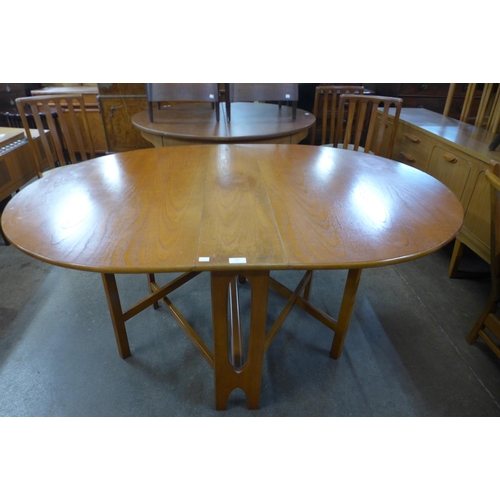 204 - A teak drop-leaf table and four chairs