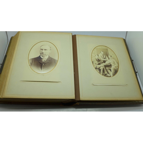 690 - A Victorian album containing eighty cabinet cards and carte de visite