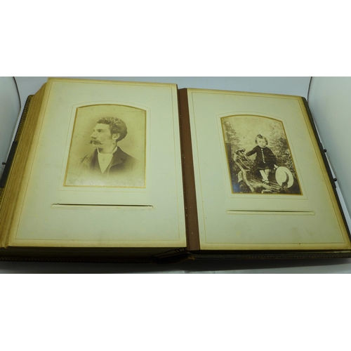 690 - A Victorian album containing eighty cabinet cards and carte de visite