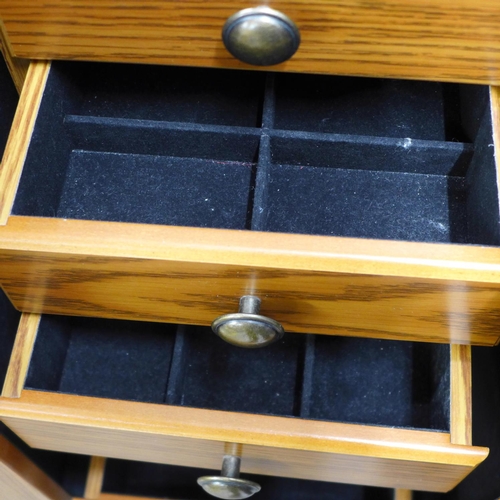 716 - A large jewellery chest with costume jewellery, tie-pins and cufflinks