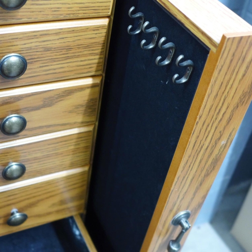 716 - A large jewellery chest with costume jewellery, tie-pins and cufflinks