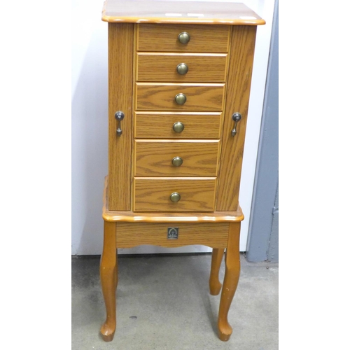 716 - A large jewellery chest with costume jewellery, tie-pins and cufflinks