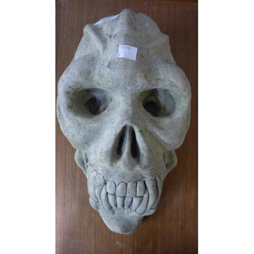 381 - A concrete primate skull garden ornament