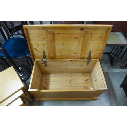 336 - A pine blanket box and an oak nest of tables