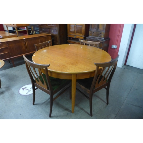 119 - A teak extending dining table and four chairs