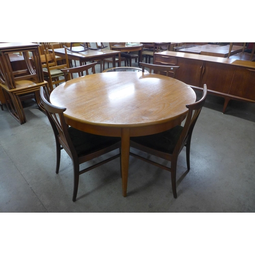 119 - A teak extending dining table and four chairs