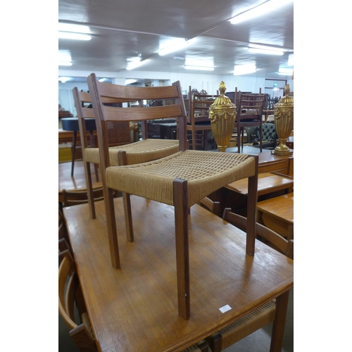 153 - A Danish teak draw-leaf dining table and six chairs