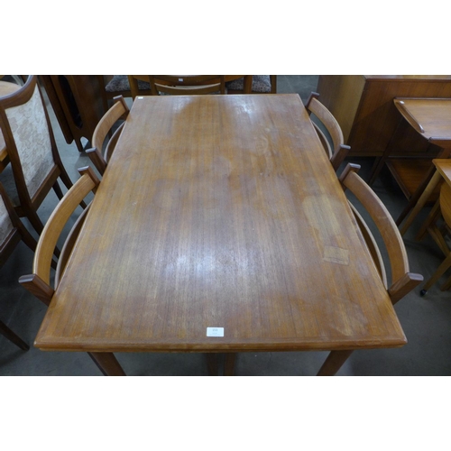 153 - A Danish teak draw-leaf dining table and six chairs