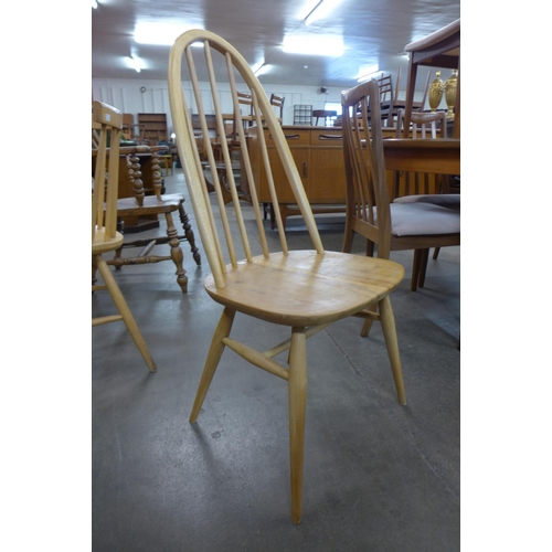 164 - An Ercol Blonde Windsor elm and beech plank dining table and four chairs