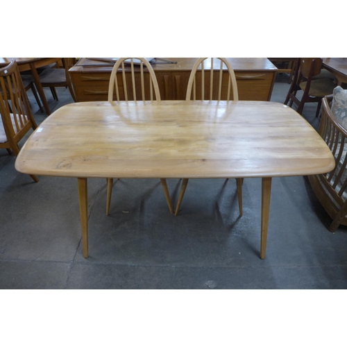 164 - An Ercol Blonde Windsor elm and beech plank dining table and four chairs