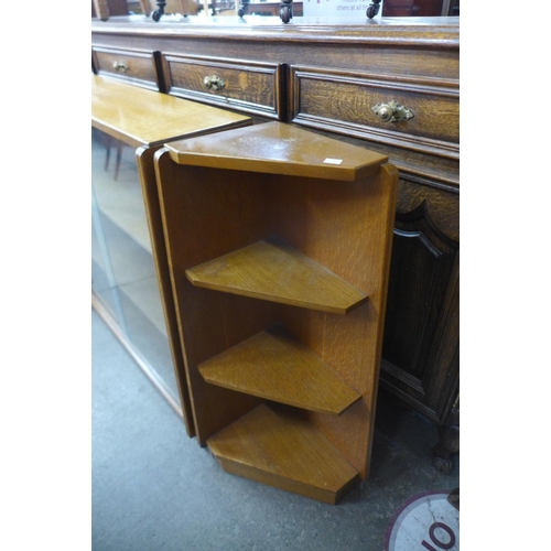 174 - A light oak bookcase and pair of matching corner cabinets