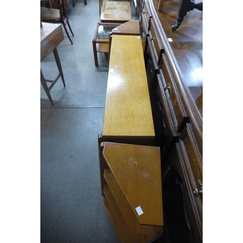 174 - A light oak bookcase and pair of matching corner cabinets