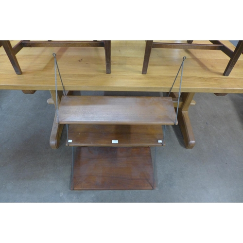 179 - A teak and metal wall hanging three tier shelf