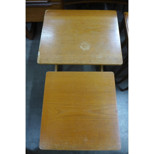 196 - A Legate teak nest of tables and a Nathan teak nest of two tables