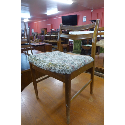 199 - A teak extending dining table and four chairs