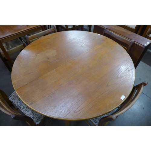 199 - A teak extending dining table and four chairs