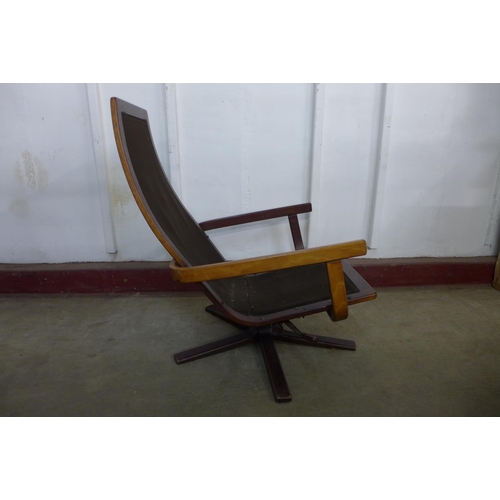 221 - A Scandinavian teak swivel lounge chair