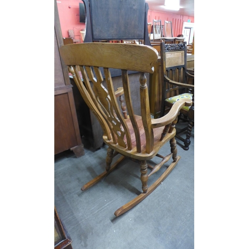 224 - A Victorian style beech rocking chair