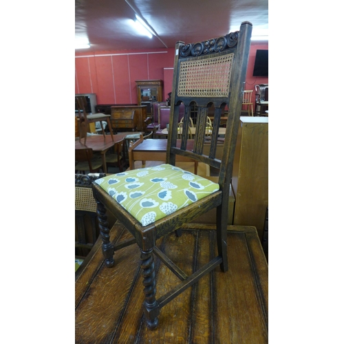 226 - An oak barleytwist draw-leaf table and six chairs