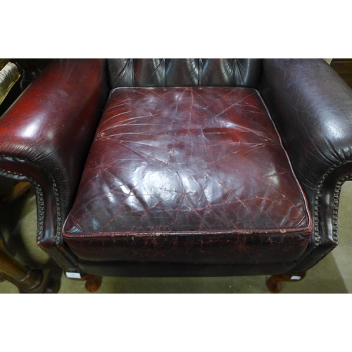 281 - A red leather Chesterfield wingback armchair