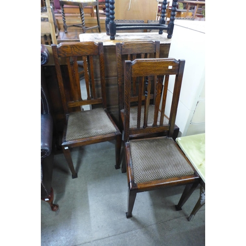 283 - A set of three oak dining chairs and a mahogany drop-leaf sofa table