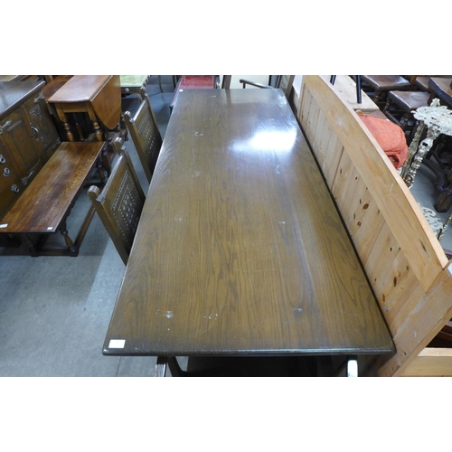 288 - An oak refectory table and eight chairs