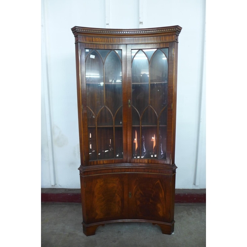 296a - A mahogany freestanding concave corner cabinet