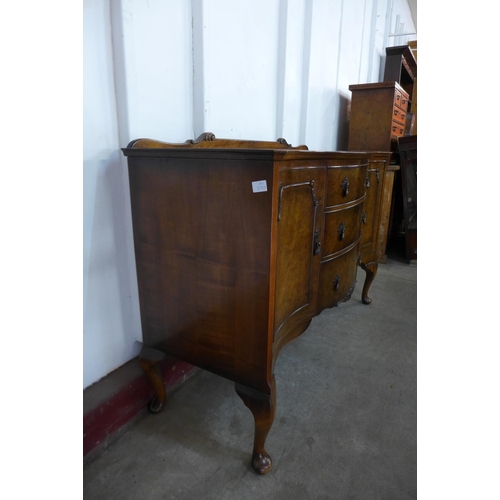 296e - A walnut serpentine sideboard