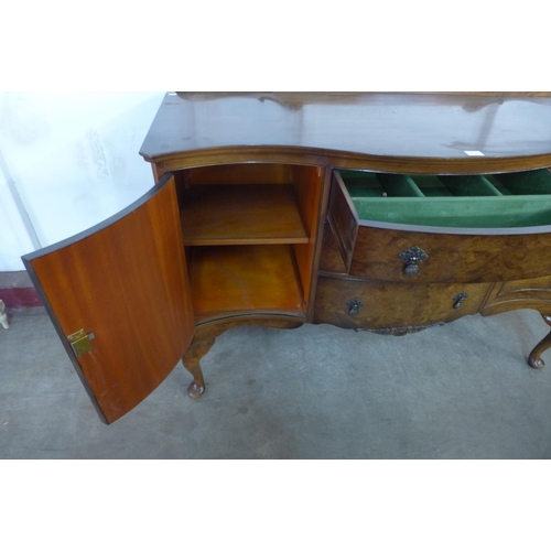 296e - A walnut serpentine sideboard