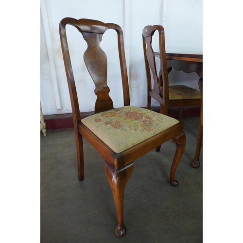 296g - A walnut draw-leaf dining table and four chairs