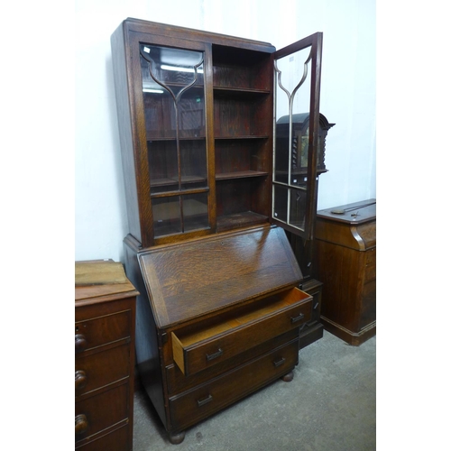 299 - An oak bureau bookcase