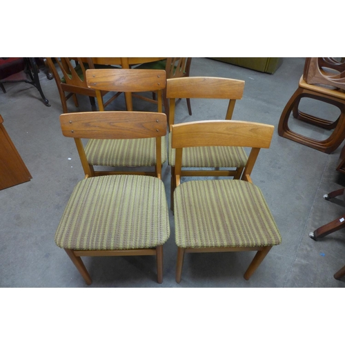 310 - A teak slot display cabinet and four teak dining chairs