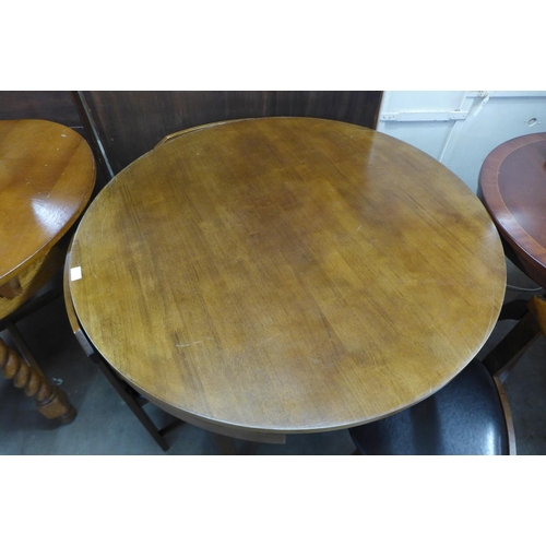 319 - A hardwood circular dining table and four chairs